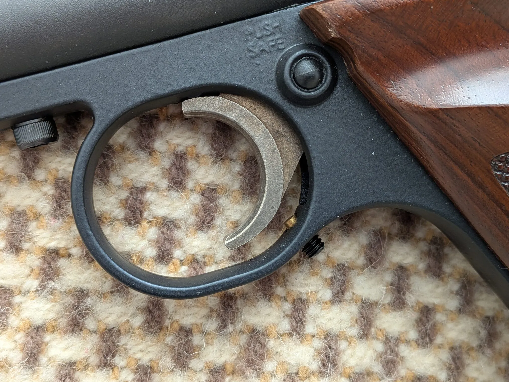 Curved trigger blade and adjustment hardware on the Crosman 1701P