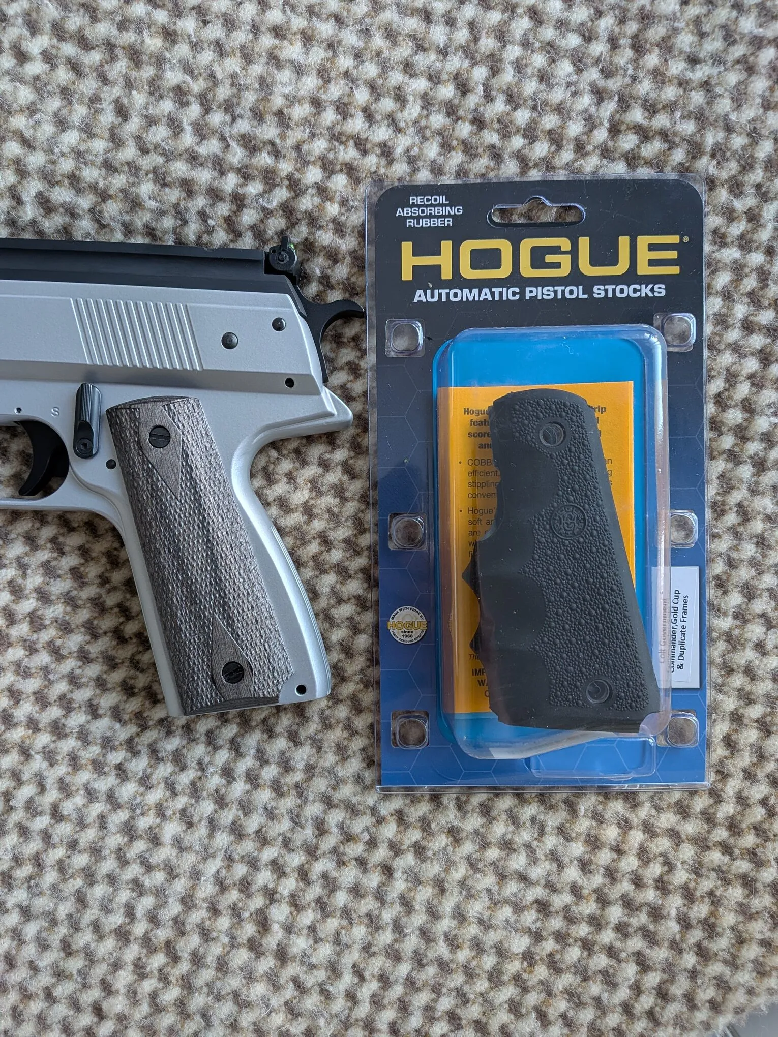 HW45 checkered grip panel and manual safety beside a packaged Hogue replacement grip