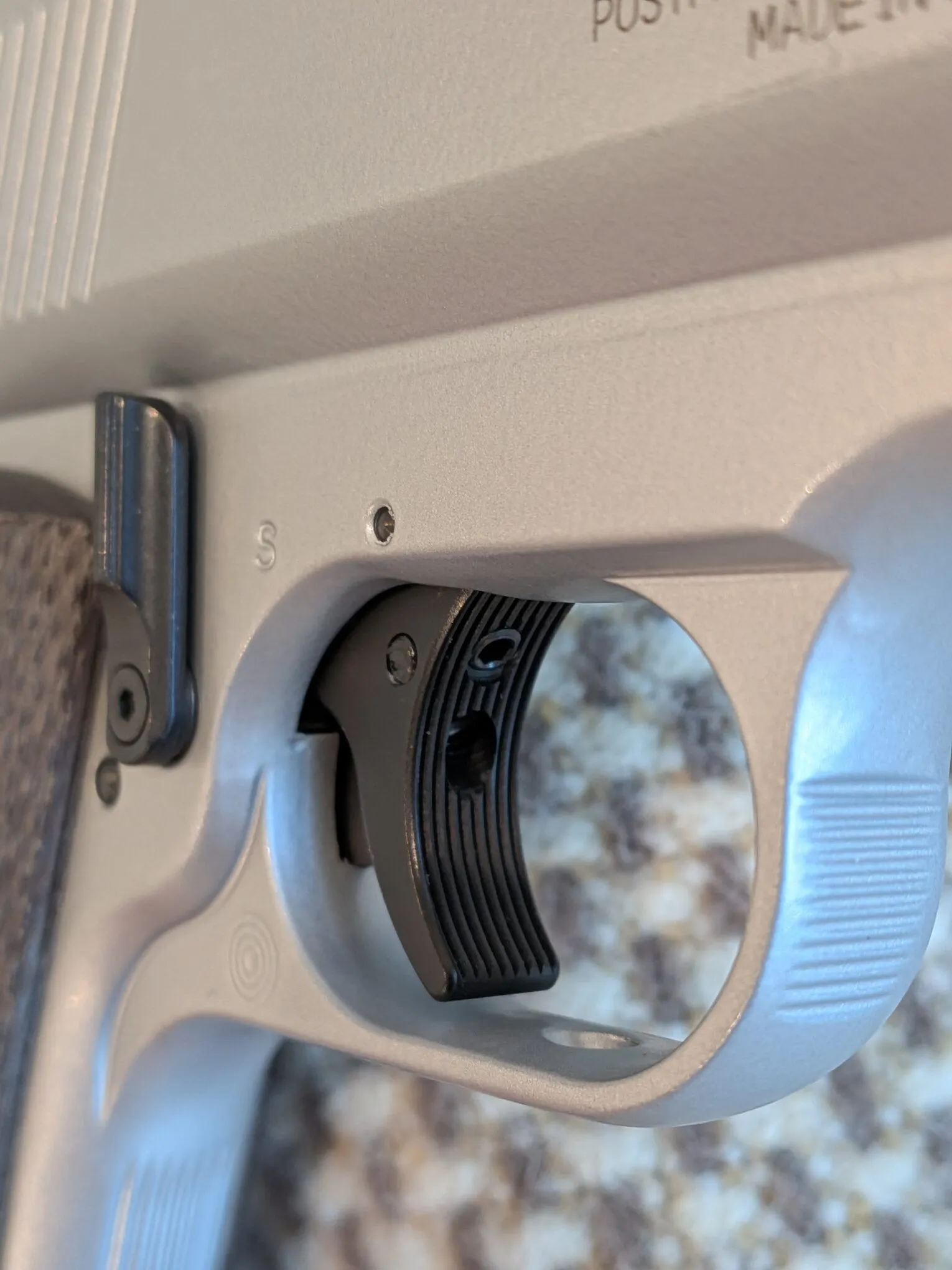 Close-up of the HW45 grooved trigger blade, adjustment openings, and safety lever