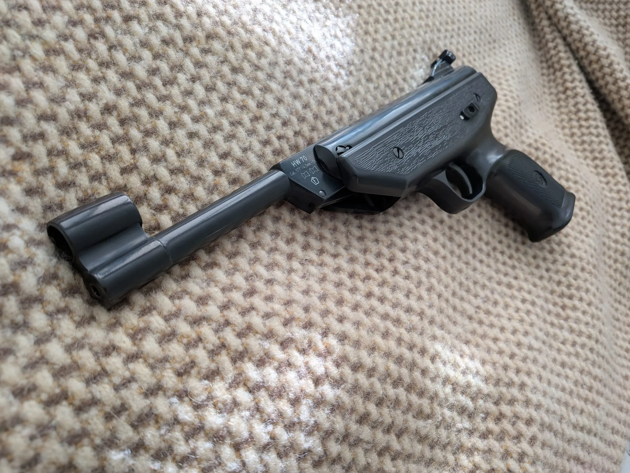 Angled view of the HW70A showing the cylinder, synthetic stock, and hooded front sight