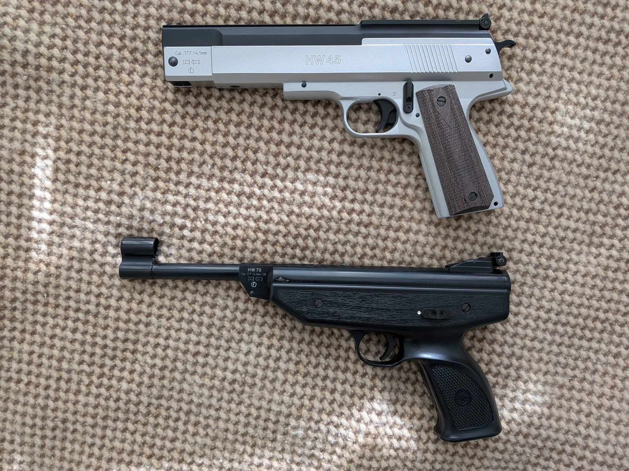 HW45 above the HW70A, comparing their outlines, grips, and barrel layouts