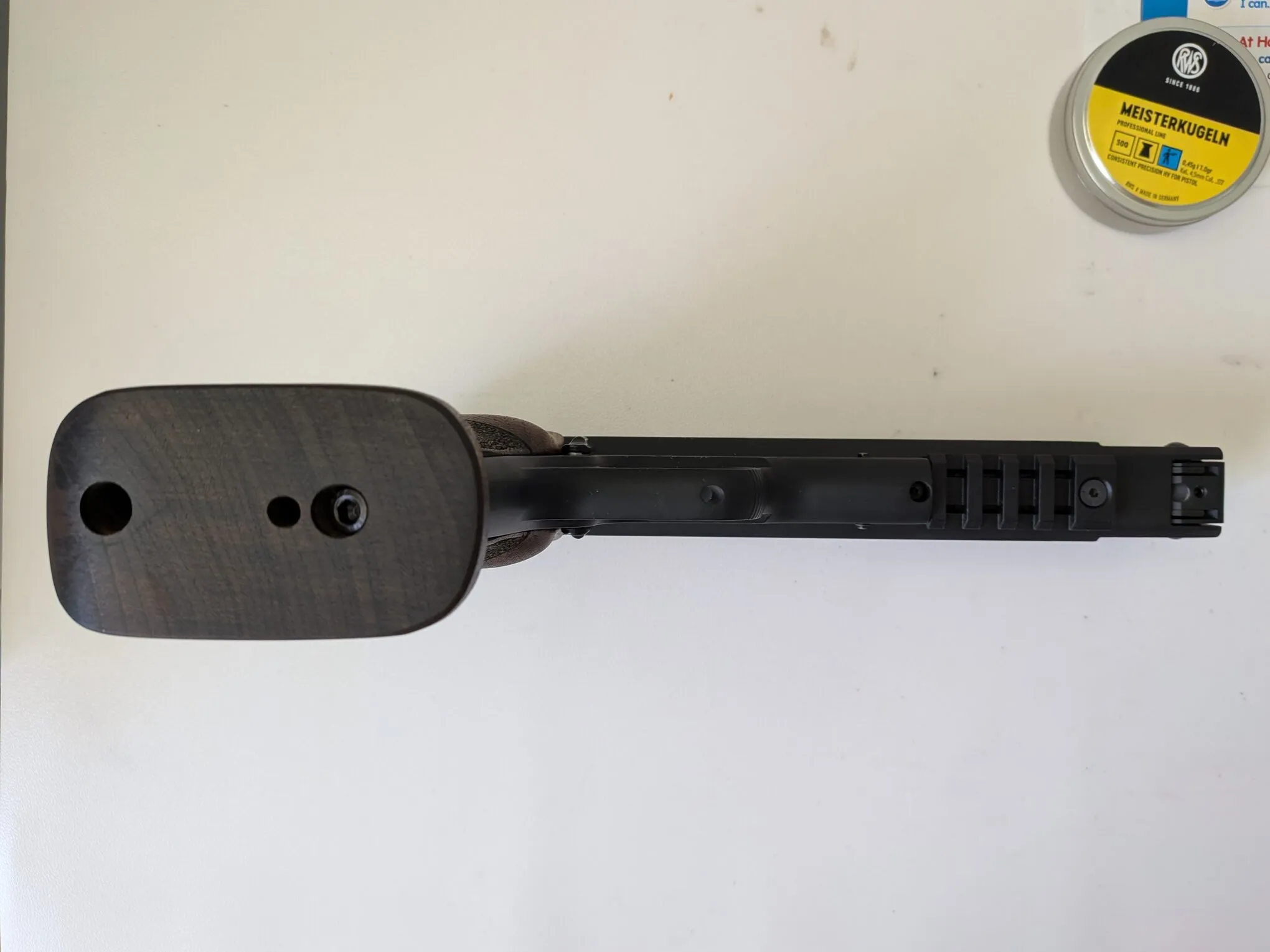 Bottom view of the HW75, showing the walnut grip base and the underside of the frame