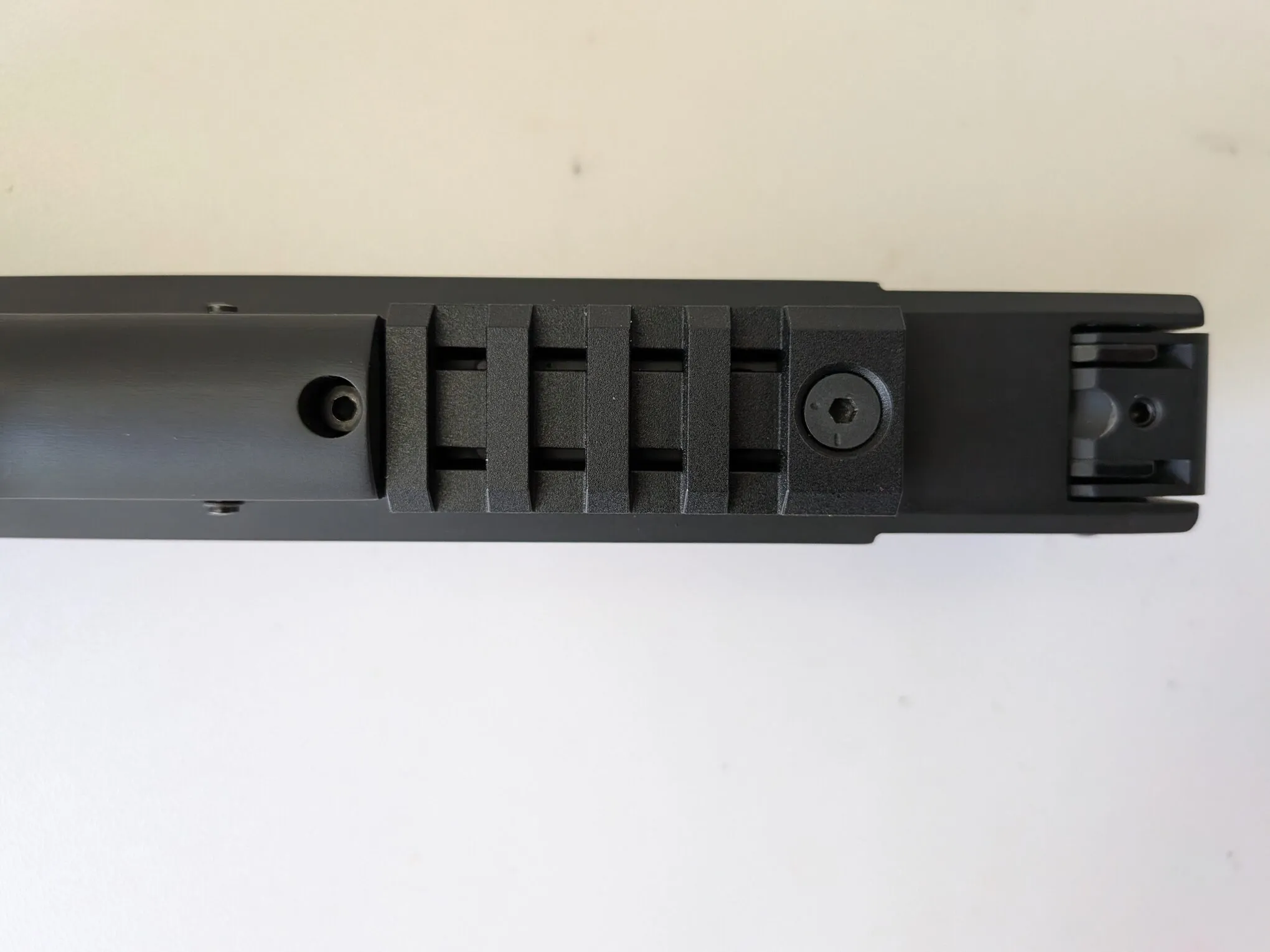 Close-up of the plastic accessory rail beneath the HW75 frame